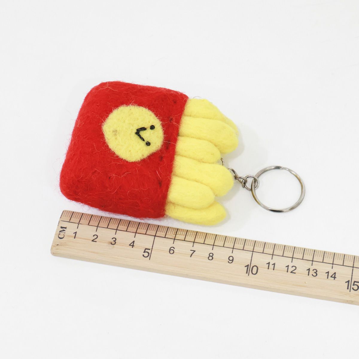 Happy fries wool felt keychain with ruler showing size, handmade quality detail shot