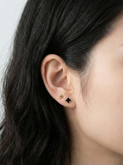 Romantic lavender mother of pearl clover piercing with titanium post layered with butterfly and CZ studs in ear cartilage