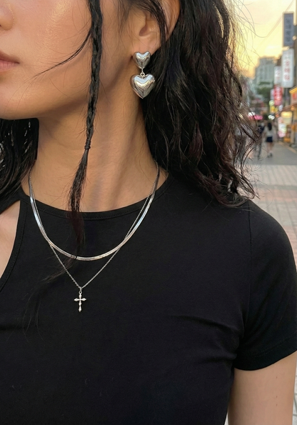 Silver heart earrings layered with chain necklace and cross pendant - Y2K styling