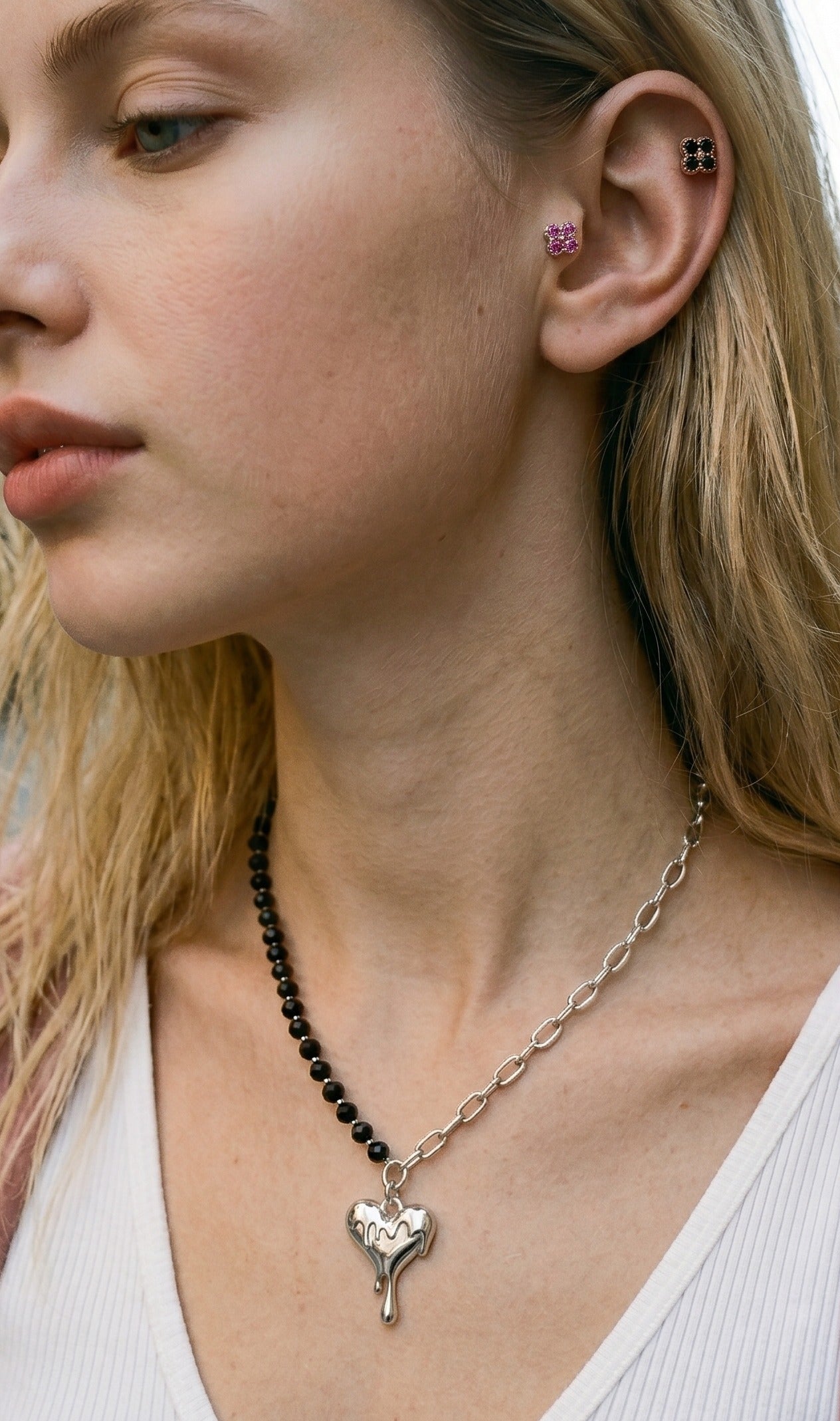 K-fashion ear curation inspo pink black clover cubic zirconia stud piercing with melting heart surgical steel necklace, curated ear stack hypoallergenic daily look.