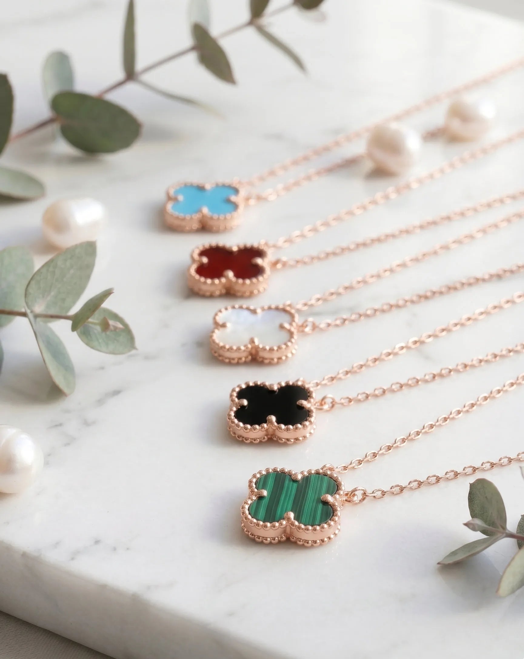 Rose gold clover gemstone necklace 5 color lineup 925 silver bezel-set pendant hypoallergenic K-style jewelry flat lay.