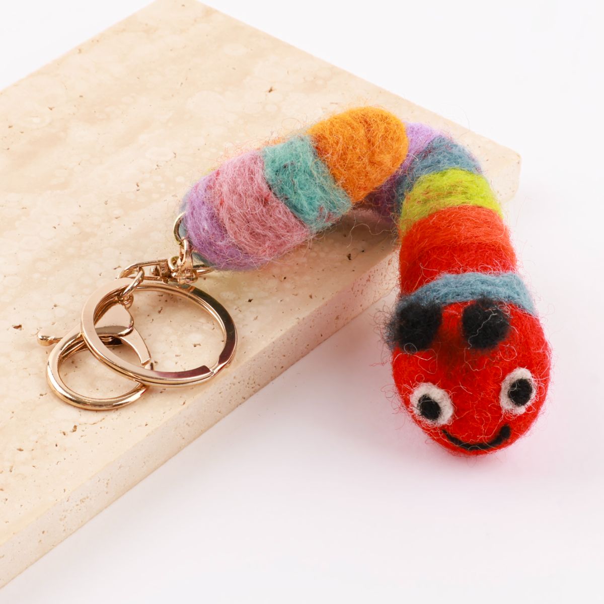 Rainbow caterpillar wool felt keychain showing vibrant multicolor segments handmade