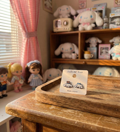 Cinnamoroll character earrings packaged on silver post card with kawaii room background