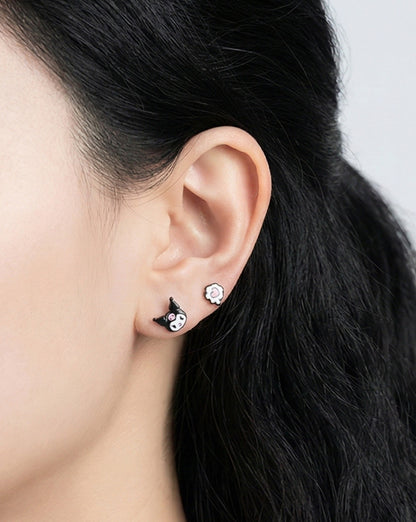 Woman wearing Kuromi and heart enamel stud earrings, side profile showing cute character design pair, 925 sterling silver posts hypoallergenic, Korean handmade Sanrio jewelry
