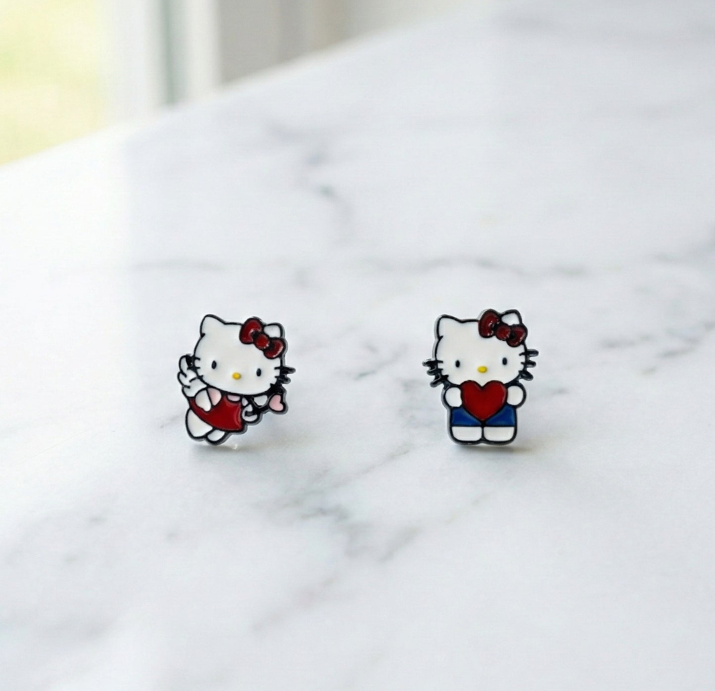 Handmade Hello Kitty enamel stud earrings in Heart Hug and Angel Cupid designs with surgical steel posts