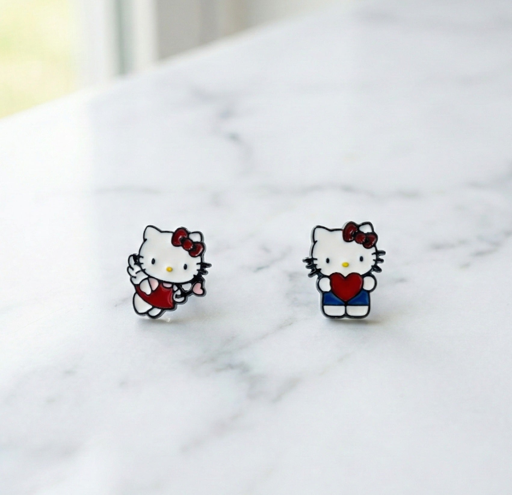 Handmade Hello Kitty enamel stud earrings in Heart Hug and Angel Cupid designs with surgical steel posts