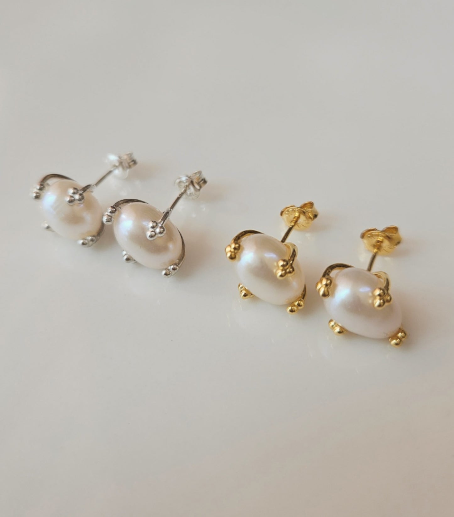Gold and silver pearl stud earrings displayed on a clean white background.