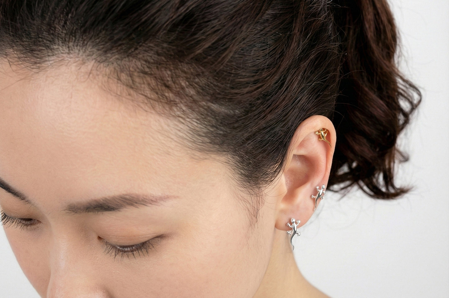 Surgical steel gecko lizard cartilage piercing worn on helix and inner conch showing detailed design with cubic zirconia