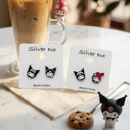 Korean handmade Kuromi and My Melody mismatched earrings with iced coffee and Sanrio figurines on white table