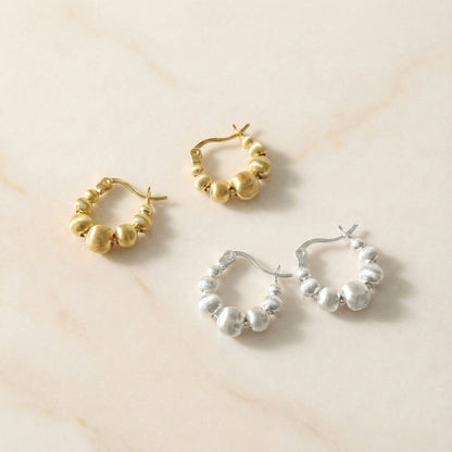 Textured beaded hoop earrings set in gold and silver tones on cream background, featuring graduated spherical beads with brushed metal finish, 925 sterling silver posts, Korean handmade jewelry everyday wear