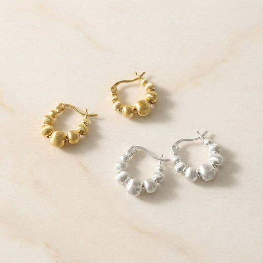 Textured beaded hoop earrings set in gold and silver tones on cream background, featuring graduated spherical beads with brushed metal finish, 925 sterling silver posts, Korean handmade jewelry everyday wear