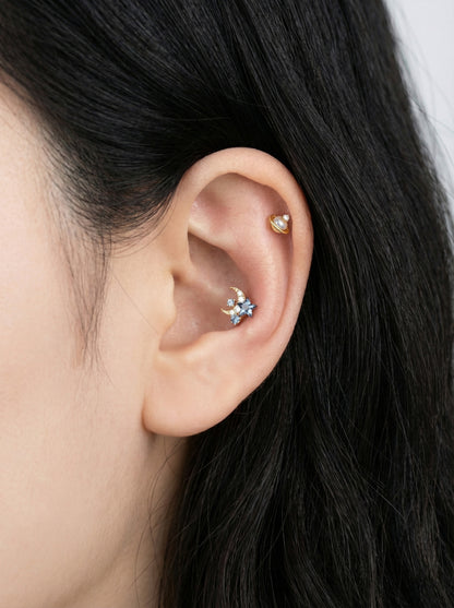 Gold Saturn pearl planet barbell piercing with cubic zirconia on ear with heart cartilage stud