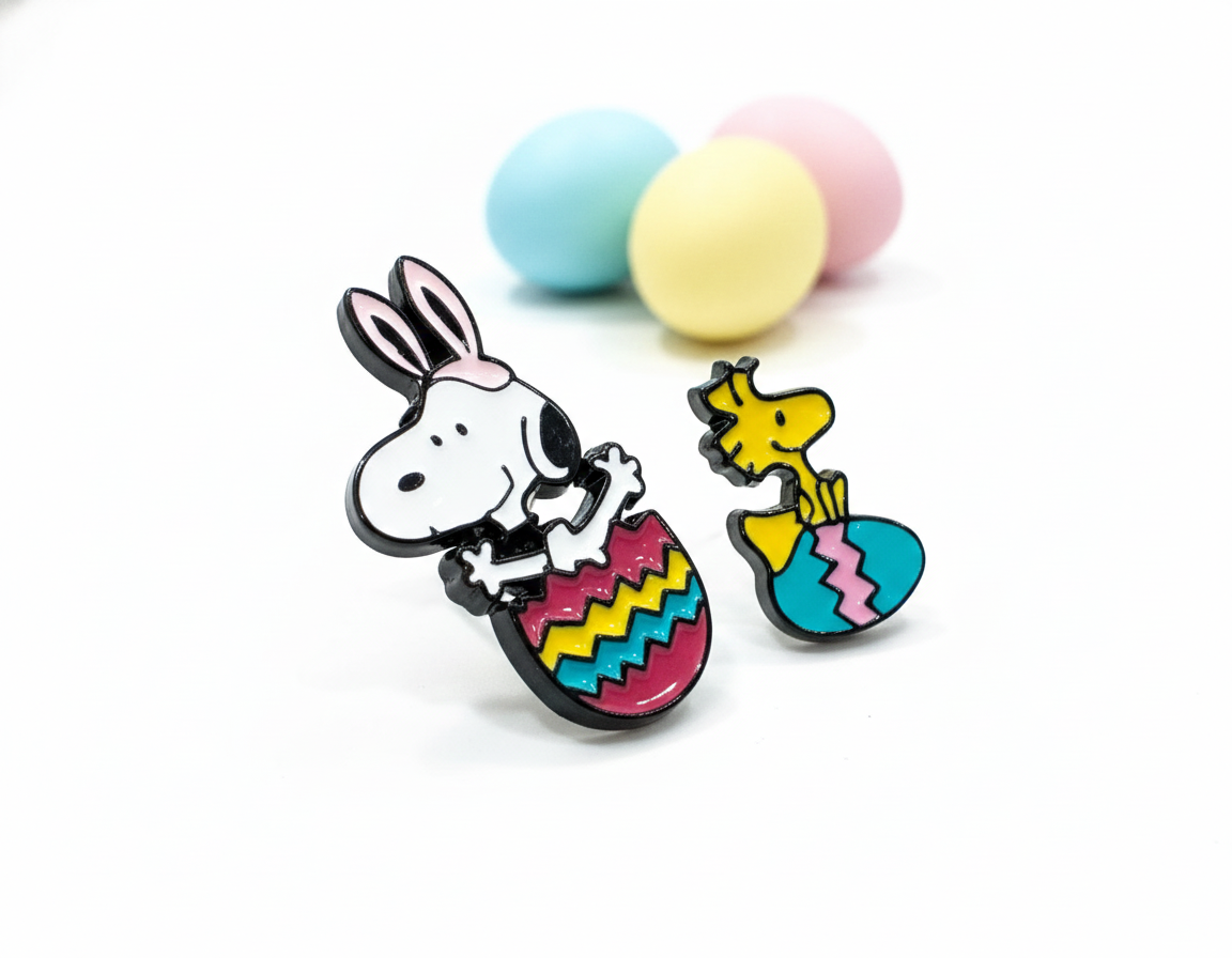 Snoopy and Woodstock Easter egg enamel earrings with pastel colored eggs in background