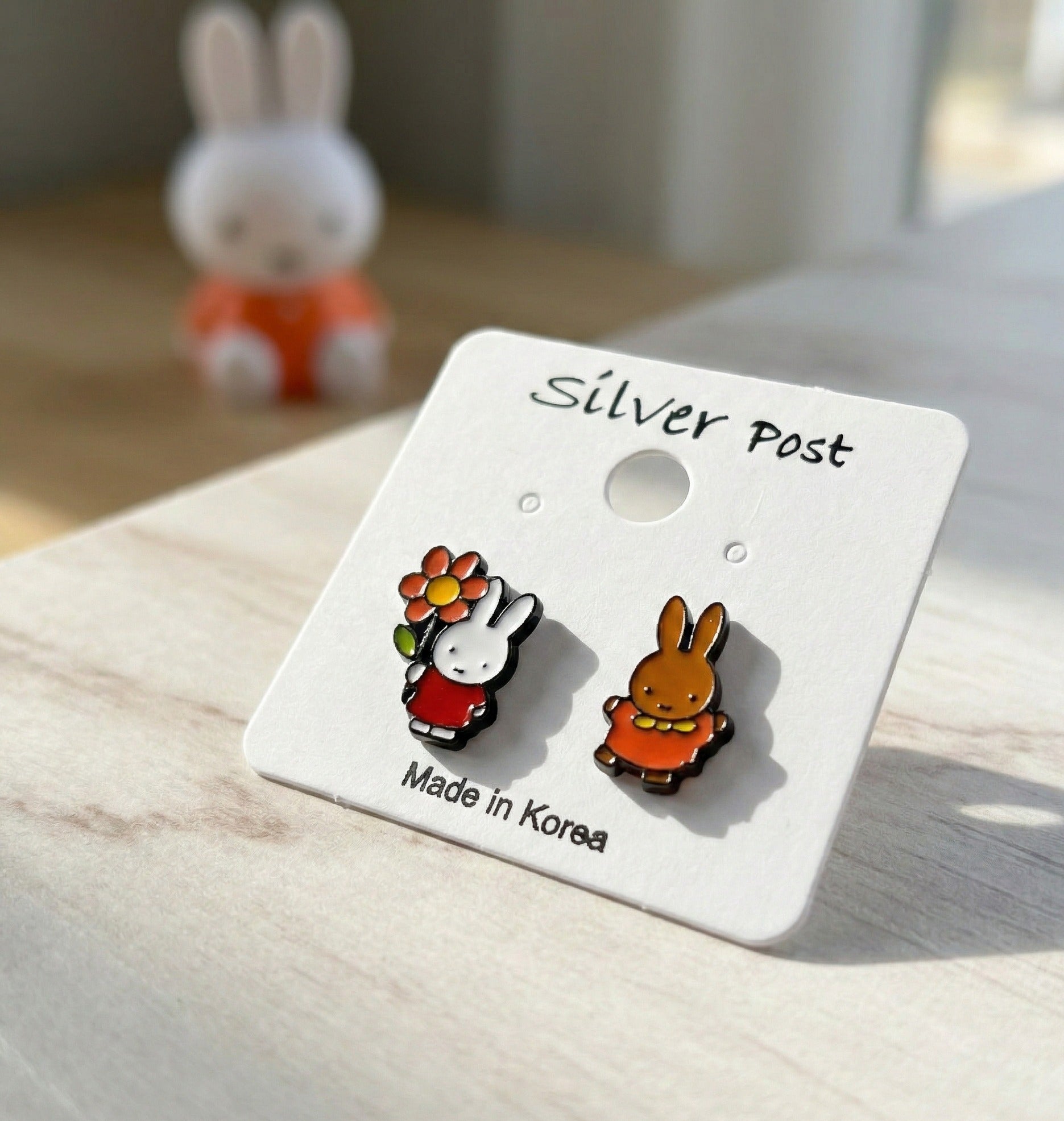 Miffy and Melanie mismatched enamel stud earrings on white card with silver post marking, Made in Korea handmade jewelry
