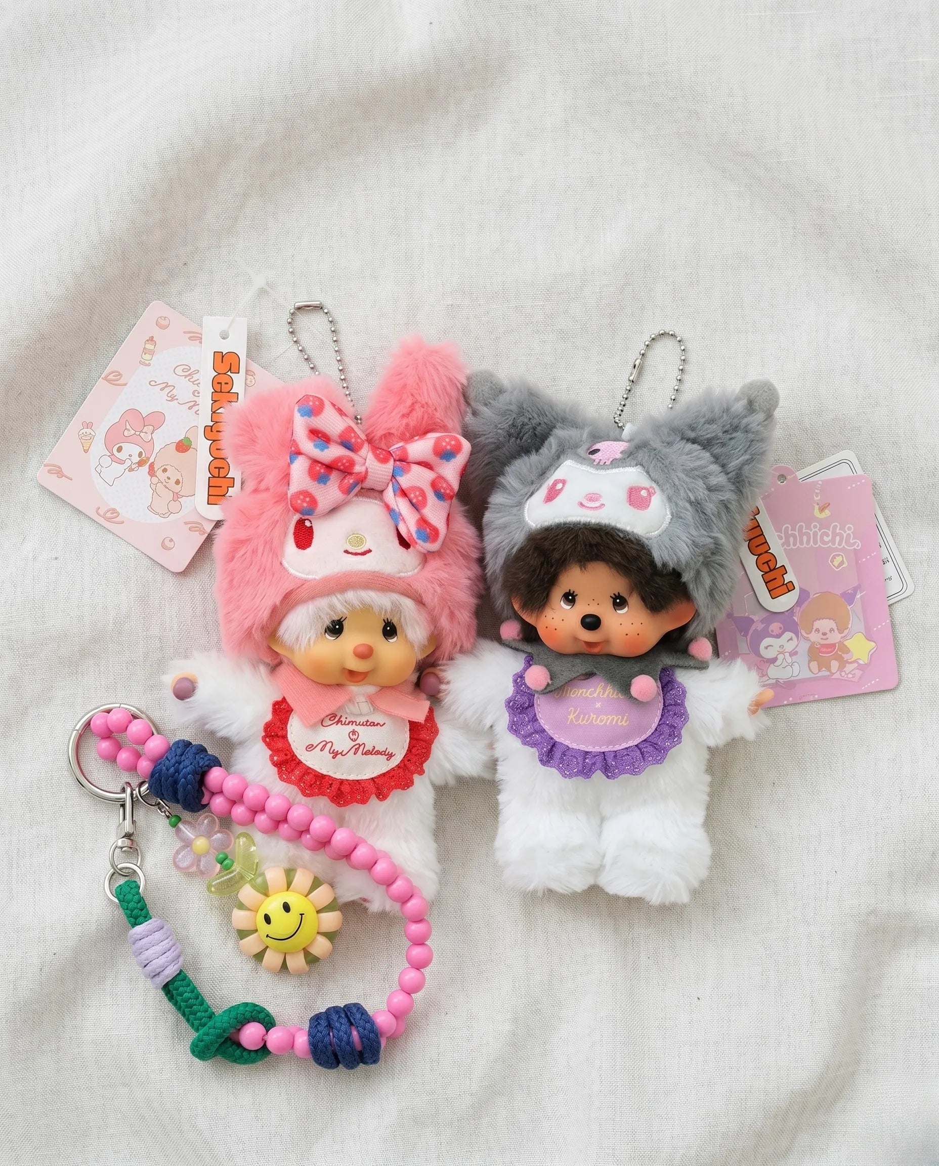 Y2K kawaii plush bag charm keychain flat lay featuring pink bunny and grunge cat ver. with smile bead strap — K-fashion bag layering inspo by 8ttitto8