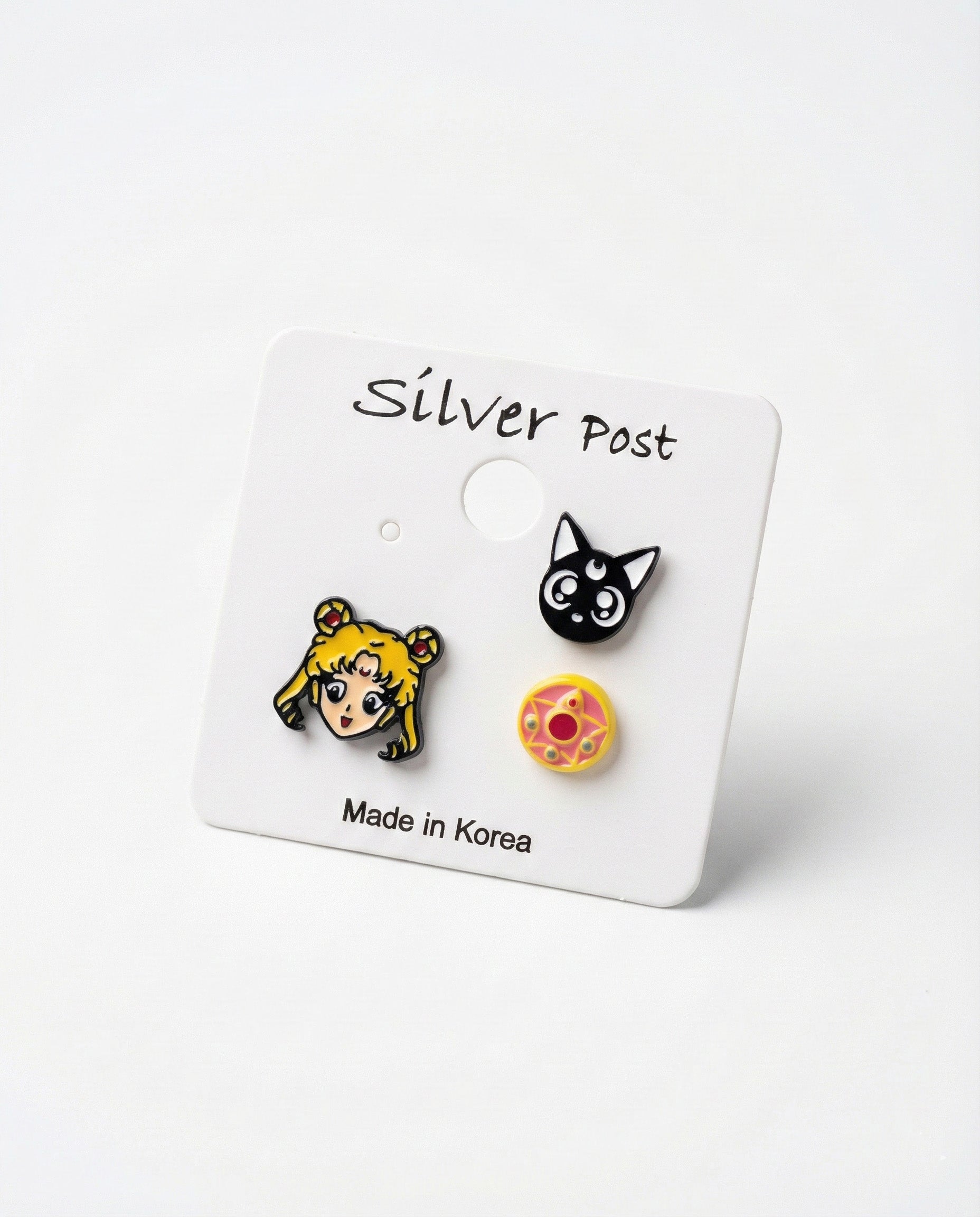Sailor Moon Luna and Crystal Star Compact 3-piece enamel earring set on white card with Made in Korea label
