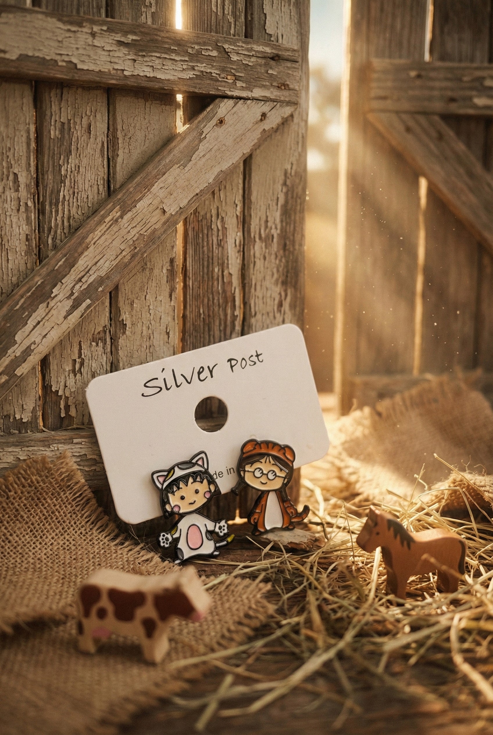 Maruko and Tamae character earring set displayed on rustic wooden background with silver post card