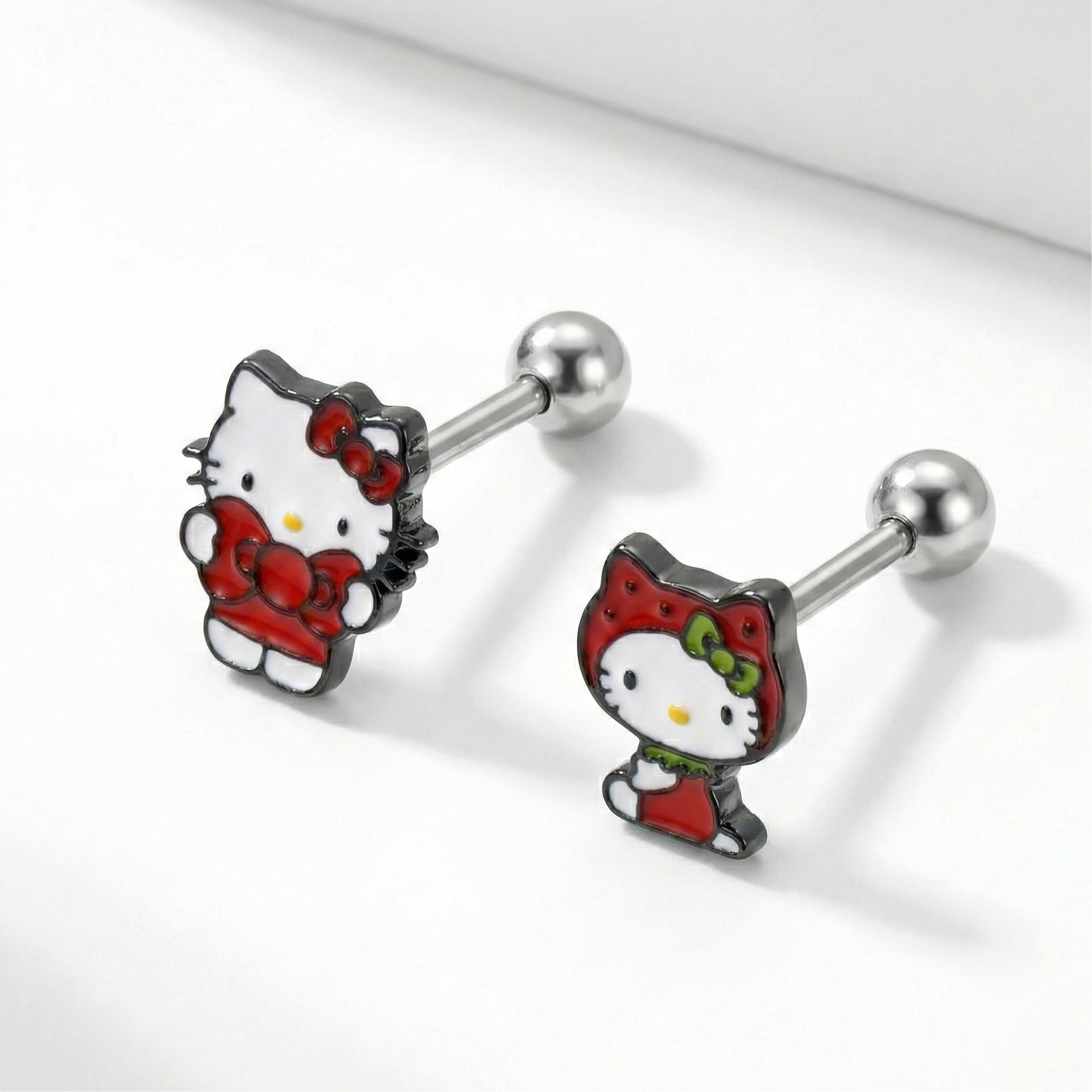  Hello Kitty surgical steel cartilage earrings in classic red ribbon and cat hood designs on white background