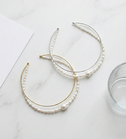 Double strand freshwater pearl and brass wire choker necklace in gold and silver on white marble