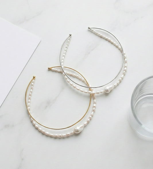 Double strand freshwater pearl and brass wire choker necklace in gold and silver on white marble