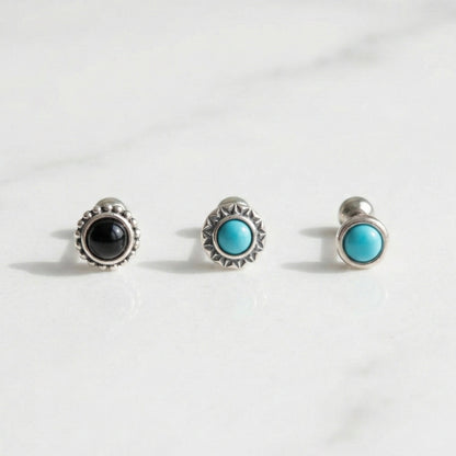 Three vintage barbell stud earrings with turquoise and onyx stones on white background