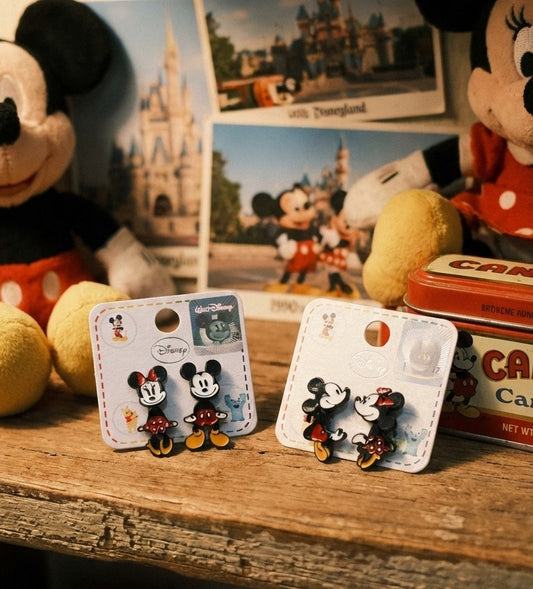 Disney authentic Mickey and Minnie front-back ear jacket earrings displayed with vintage Disneyland postcards and plush toys