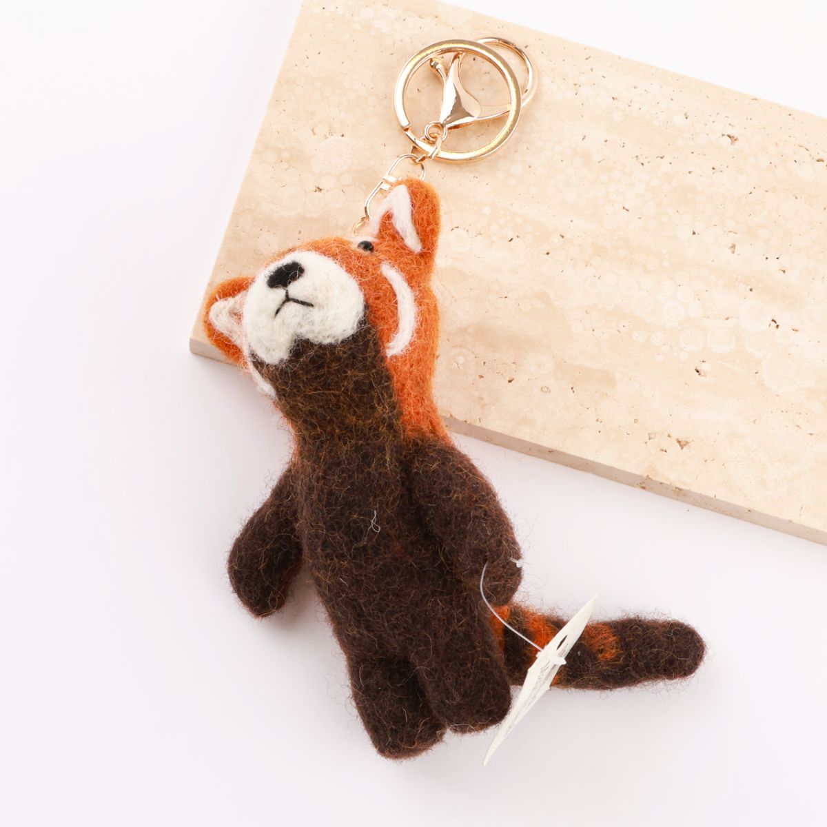 Red panda wool felt keychain showing orange and brown colors with fluffy tail detail