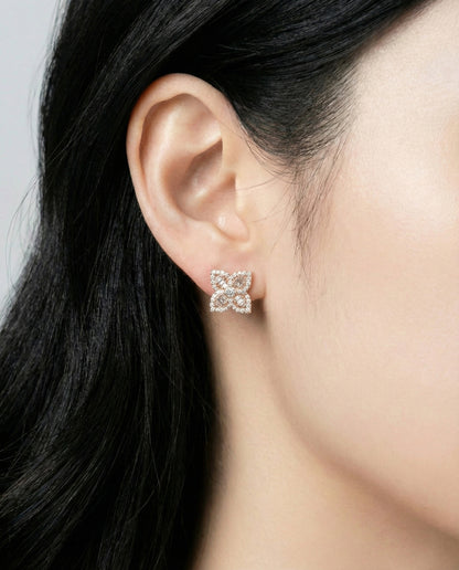 Model wearing rose gold baguette cut floral cubic zirconia stud earrings close-up