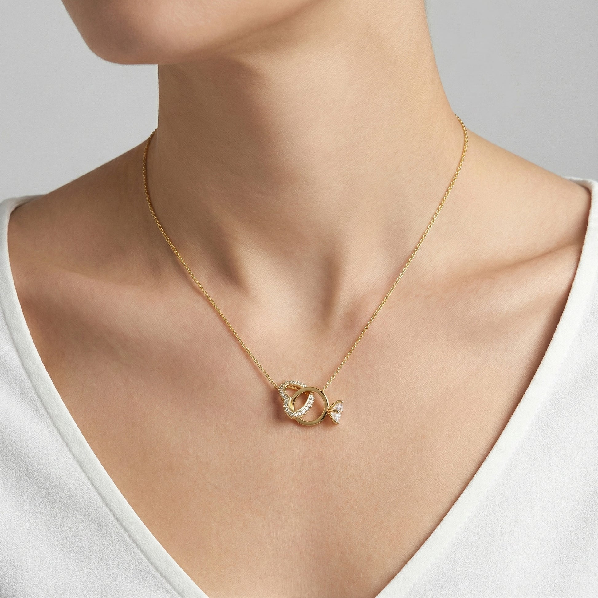  Interlocking heart and ring pendant necklace in gold on model