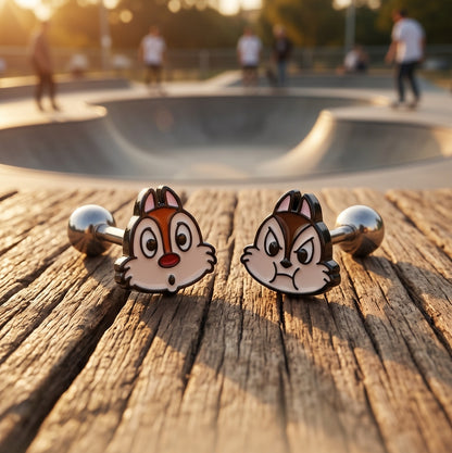 Chip and Dale hypoallergenic surgical steel barbell piercing studs flat lay on wood, K-fashion character jewelry, precision enamel detail close-up