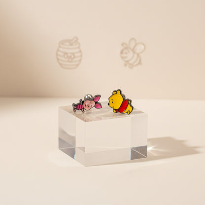 Winnie the Pooh and Piglet barbell stud earrings on acrylic display