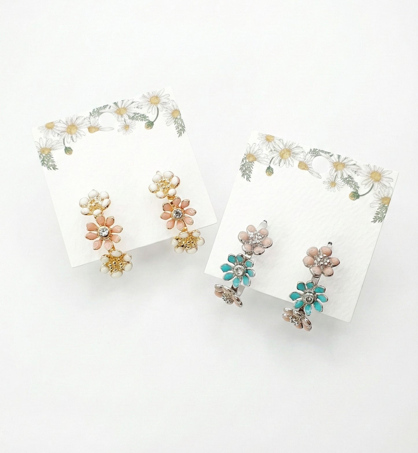 Korean handmade enamel flower hoop earrings in peach blossom and mint garden colors displayed on daisy-decorated cards