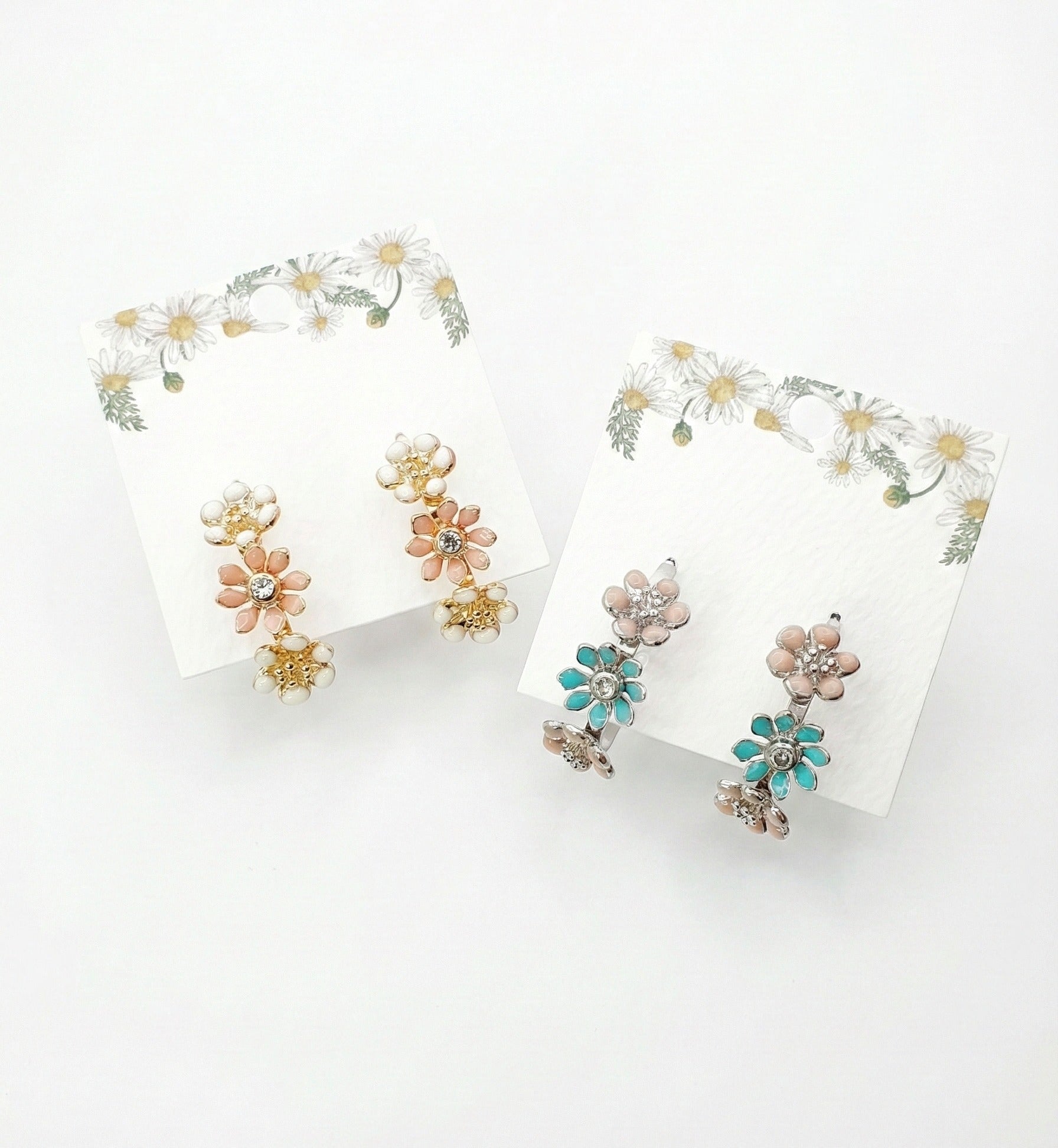 Korean handmade enamel flower hoop earrings in peach blossom and mint garden colors displayed on daisy-decorated cards