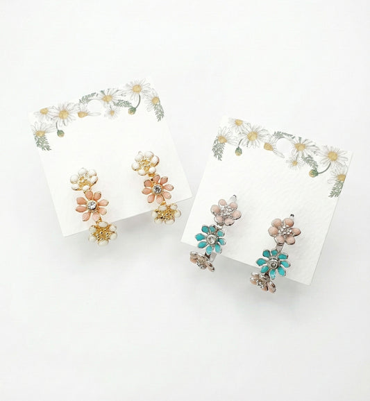 Korean handmade enamel flower hoop earrings in peach blossom and mint garden colors displayed on daisy-decorated cards