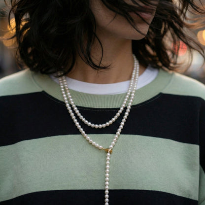 Pearl lariat necklace layered with silver chain - striped sweatshirt styling