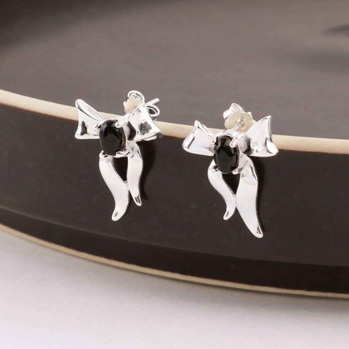 925 sterling silver black agate bow stud earrings displayed on a dark ceramic dish — vintage dark coquette jewelry by 8TTITTO8