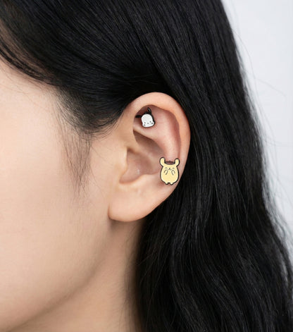 Model wearing Pompompurin titanium piercing on ear with Kuromi character showing mix and match style
