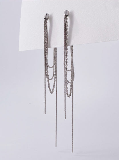 Silver layered front and back long chain drop earrings flat lay on white background
