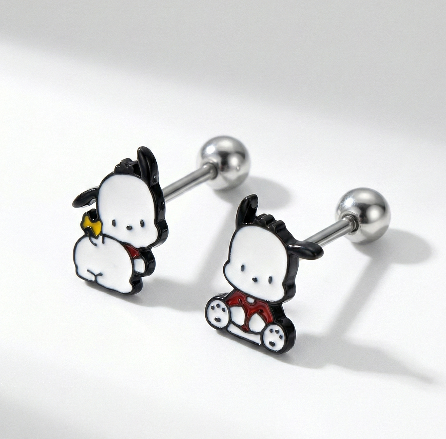 Close-up of Pochacco barbell stud earrings showing surgical steel posts