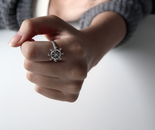 Sterling silver steering wheel ring worn on finger minimalist lifestyle photo
