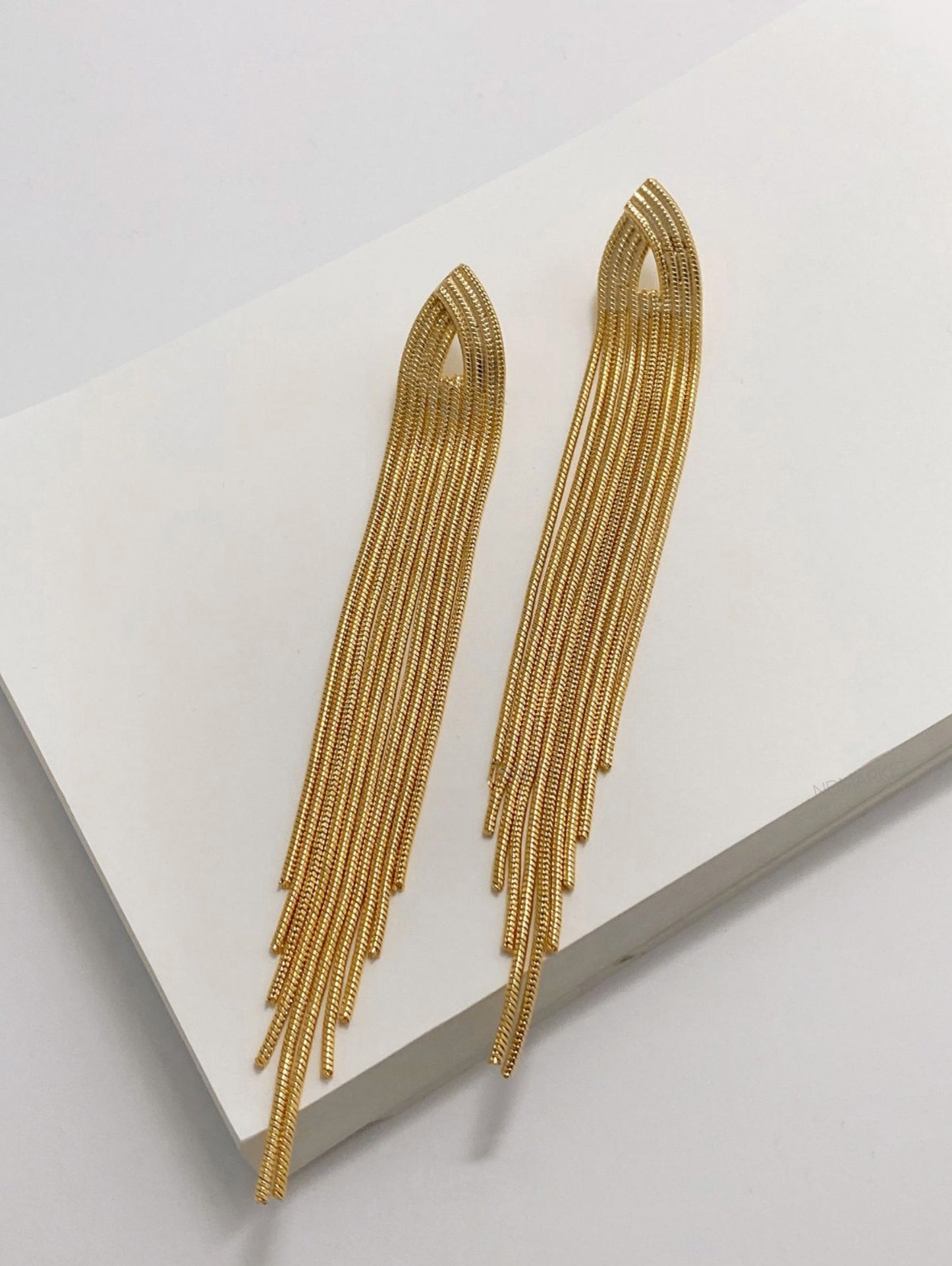 Gold chain fringe shoulder duster earrings flat lay showing premium brass construction