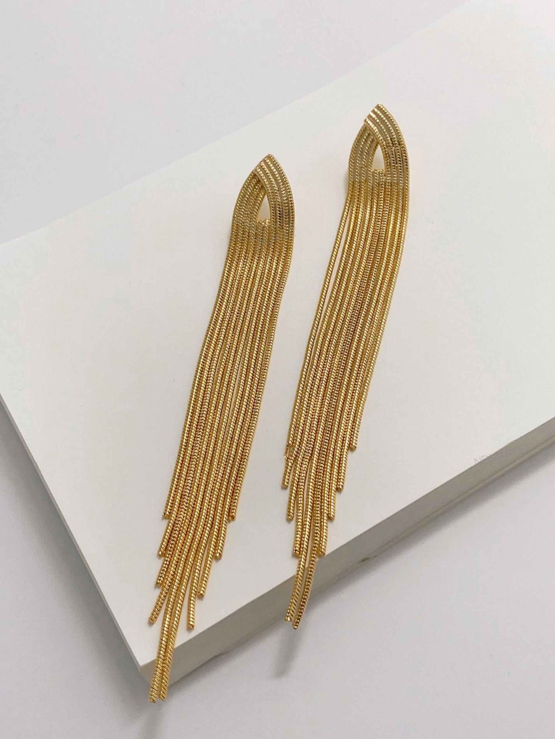 Gold chain fringe shoulder duster earrings flat lay showing premium brass construction