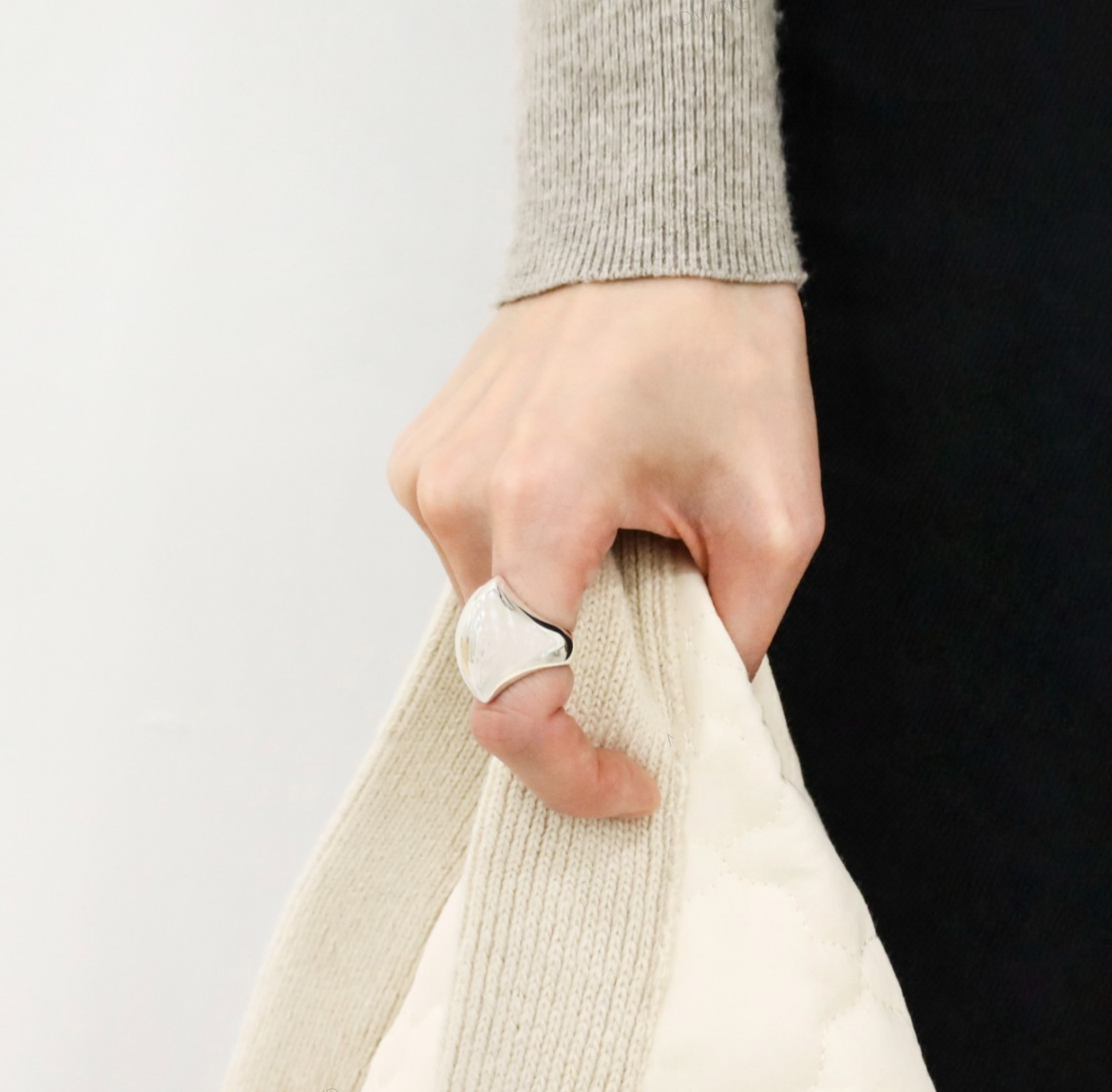 Bold silver statement ring on hand