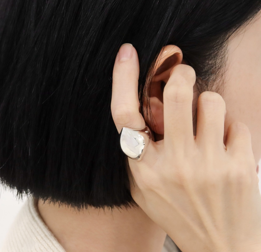 Woman wearing sculptural wave silver ring