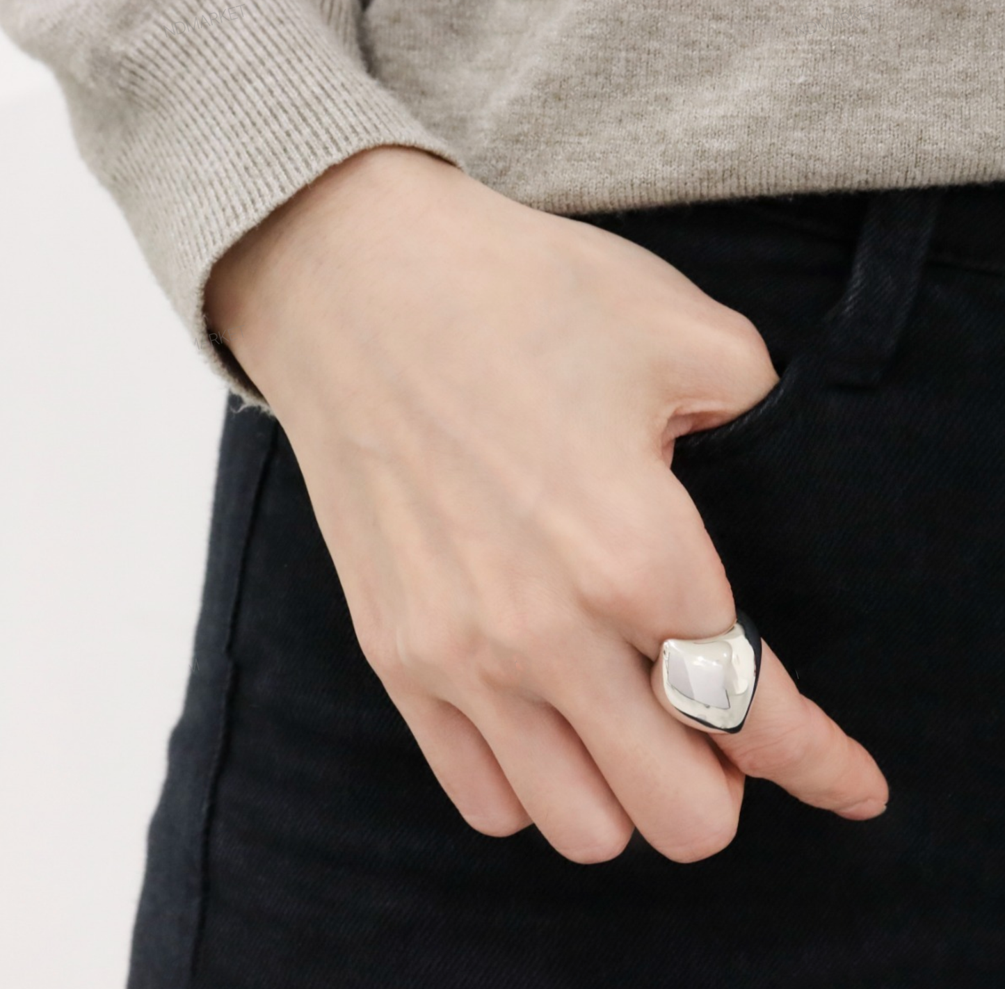 Bold silver statement ring on hand
