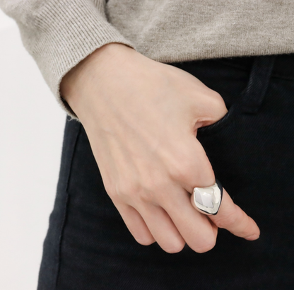 Bold silver statement ring on hand
