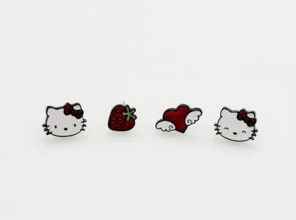 Four Hello Kitty themed enamel stud earrings on white background, featuring cat face strawberry and winged heart designs with red accents, cute Sanrio earring set, 925 silver posts, made in Korea