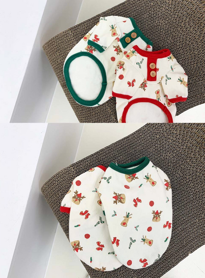Two Christmas-themed dog shirts placed side by side on a textured surface. One trimmed in red and the other in green, both showcasing festive prints.