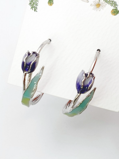 Flat lay of blue gradient tulip hoop earrings with enamel coating