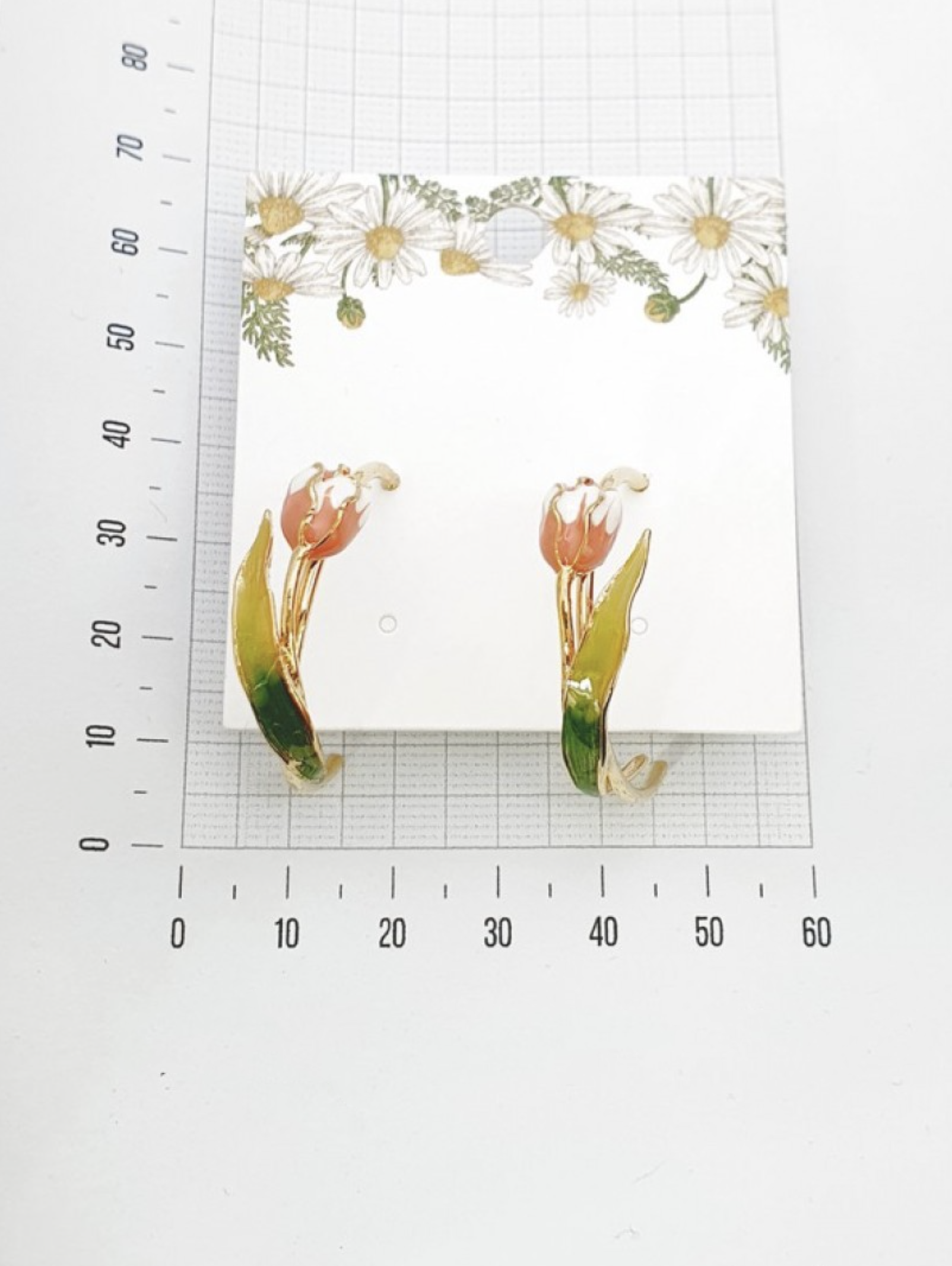 Size reference photo of handmade tulip hoop earrings with measuring tape
